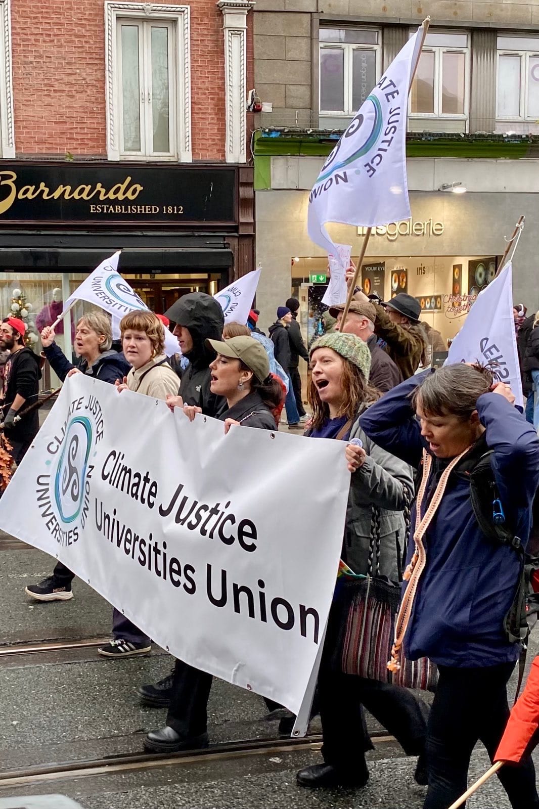 Photograph of CJUU marchers, with flags and banners, on the streets of Dublin.